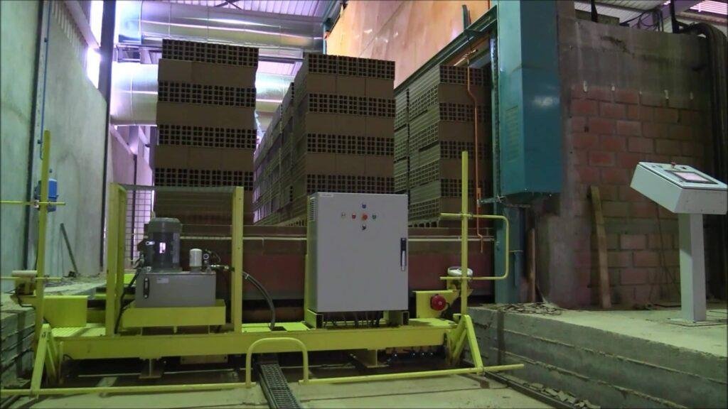 Clay product handling equipment in front of a kiln
