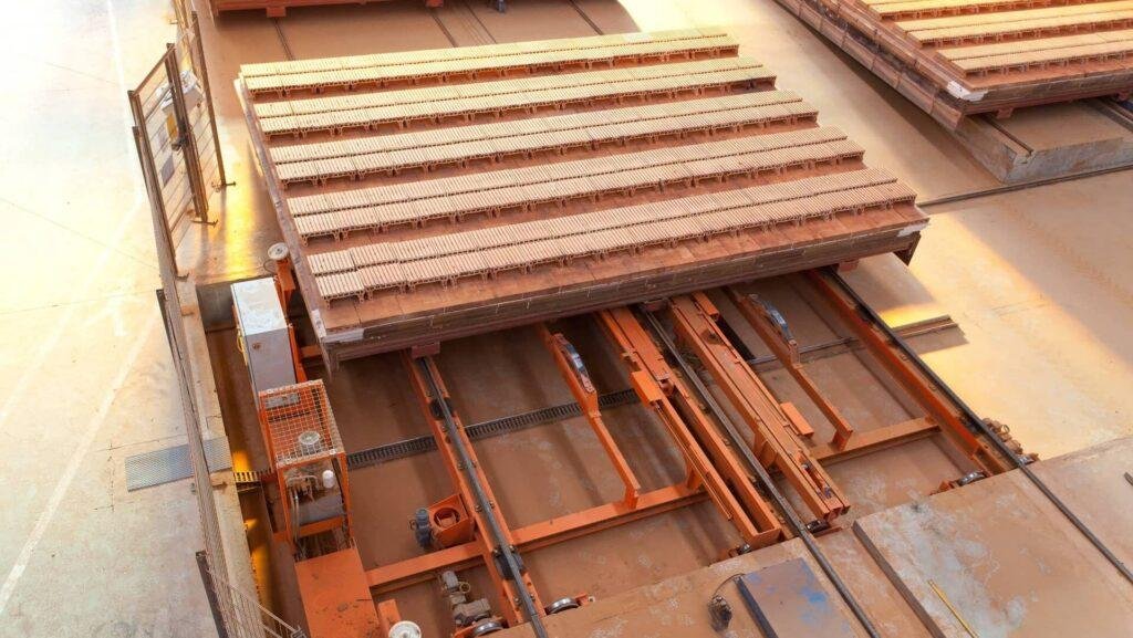Transfer mechanism for rows of clay bricks