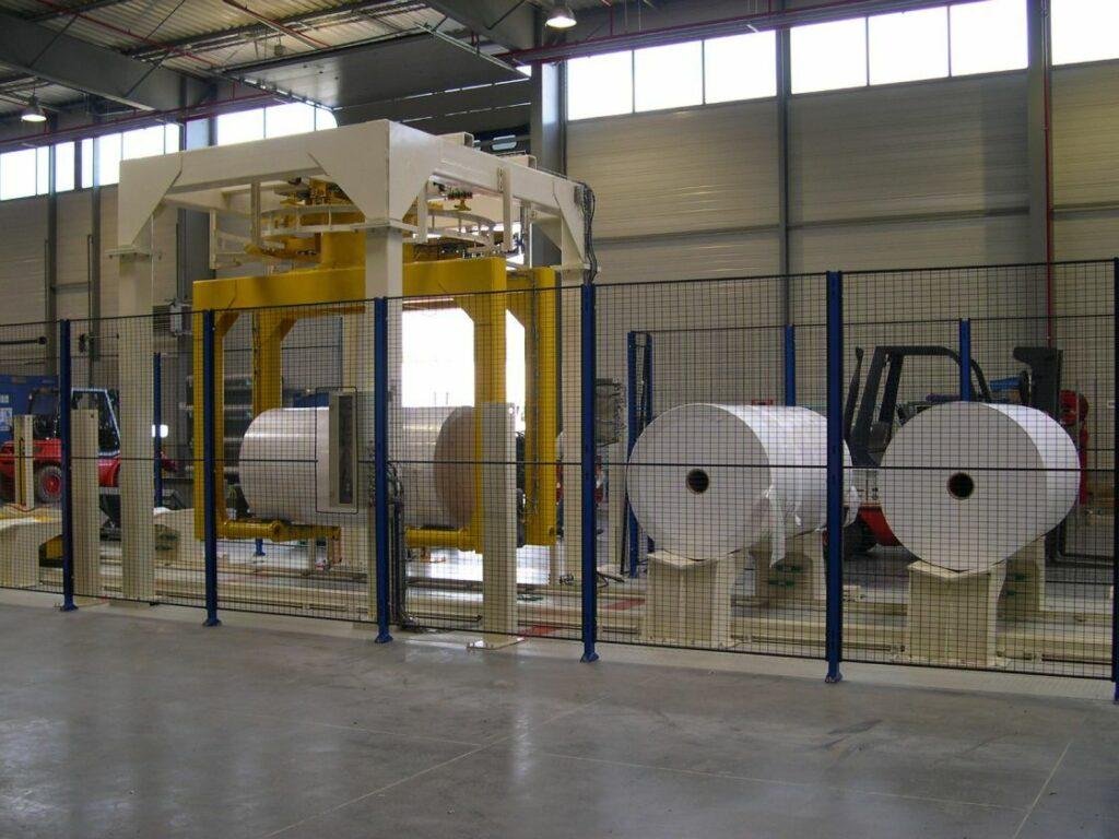 Paper reels in a handling area fitted with a gantry