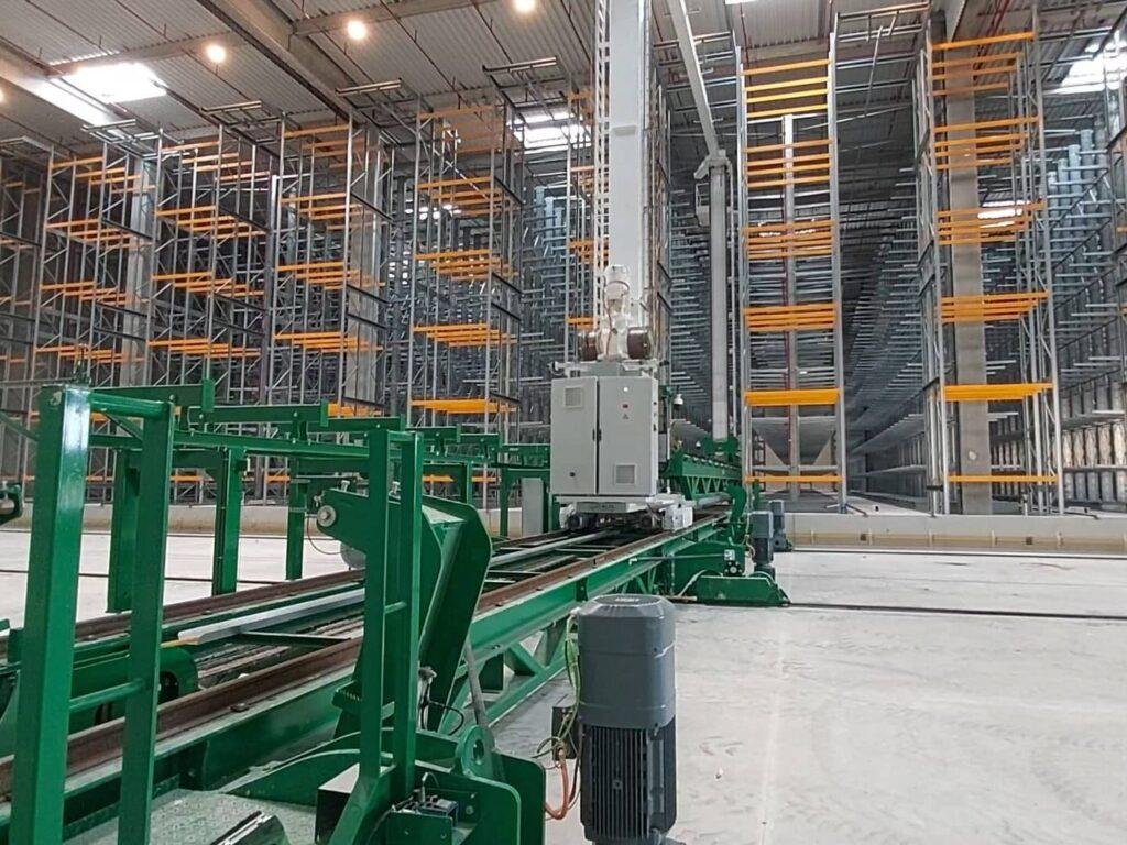 Stacker crane and conveyors in front of storage racks